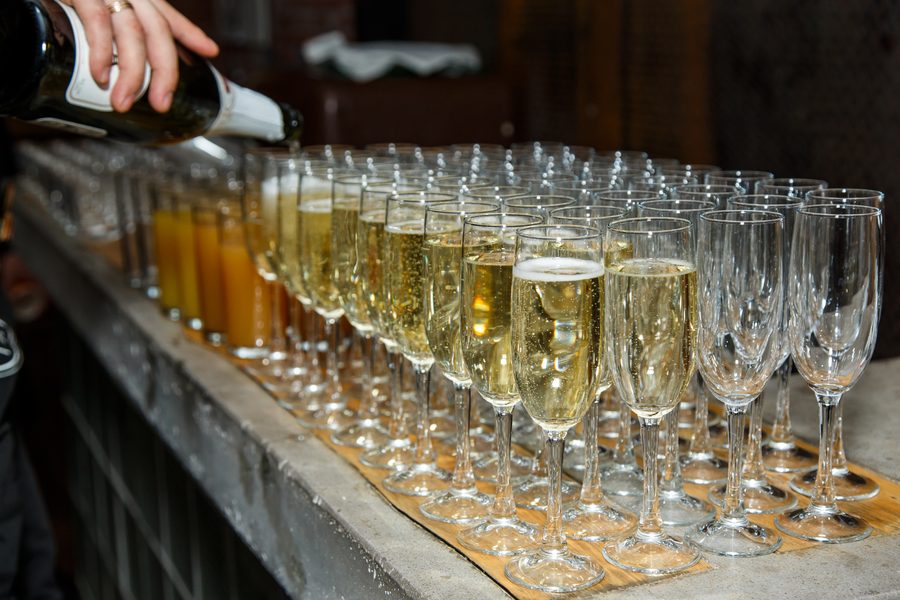 Champagne poured along a row of flutes at a festive party