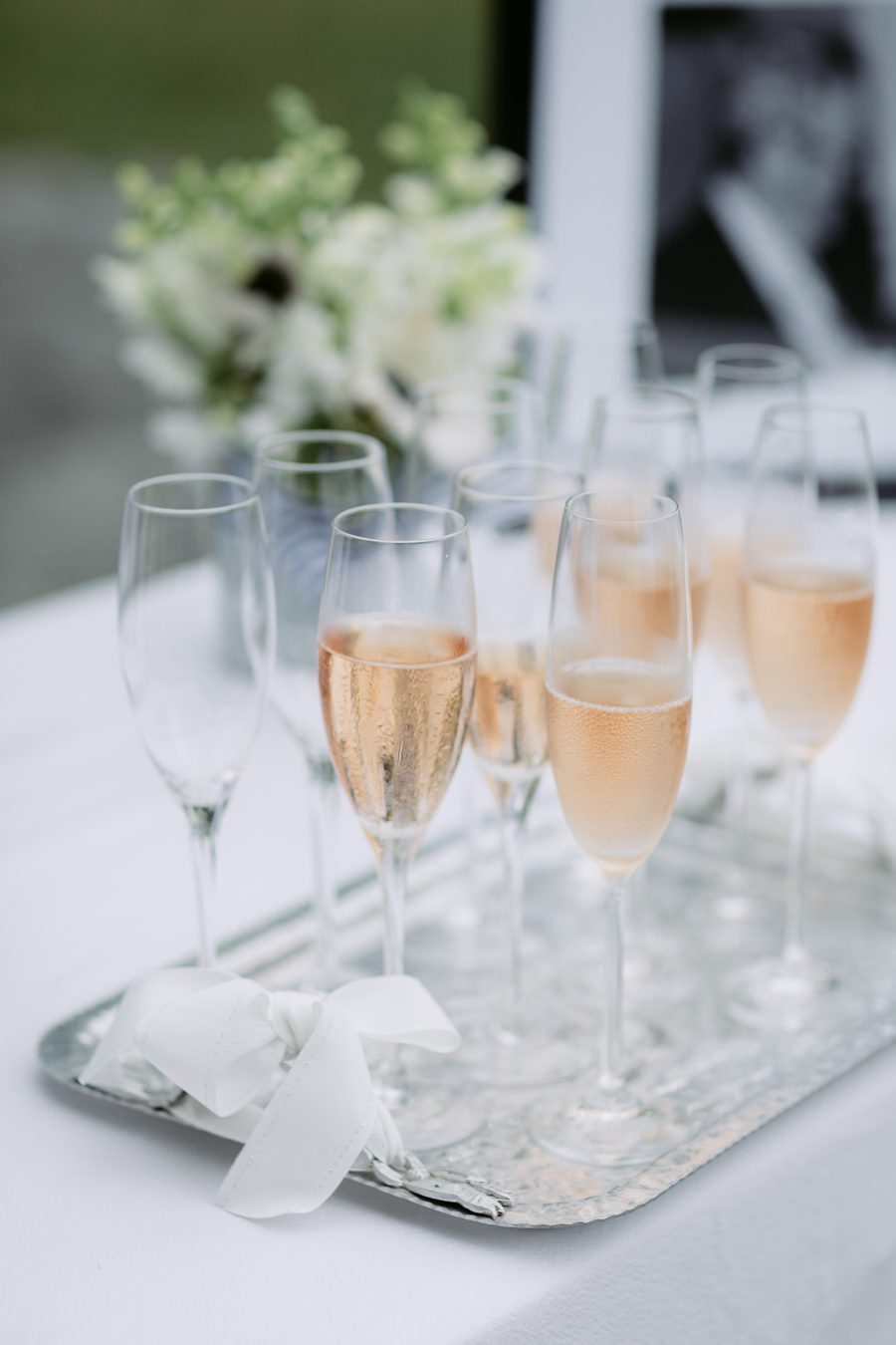 Chilled rosé champagne on a silver tray for wedding arrival drinks