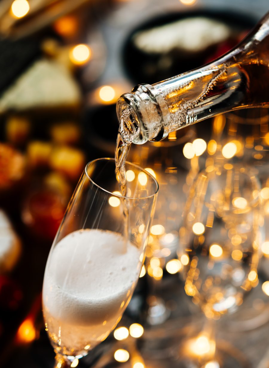 Champagne poured into a flute among festive lights