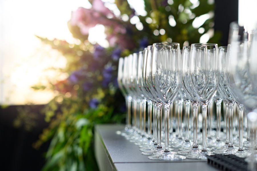 Rows of polished champagne flutes ready for a wedding reception