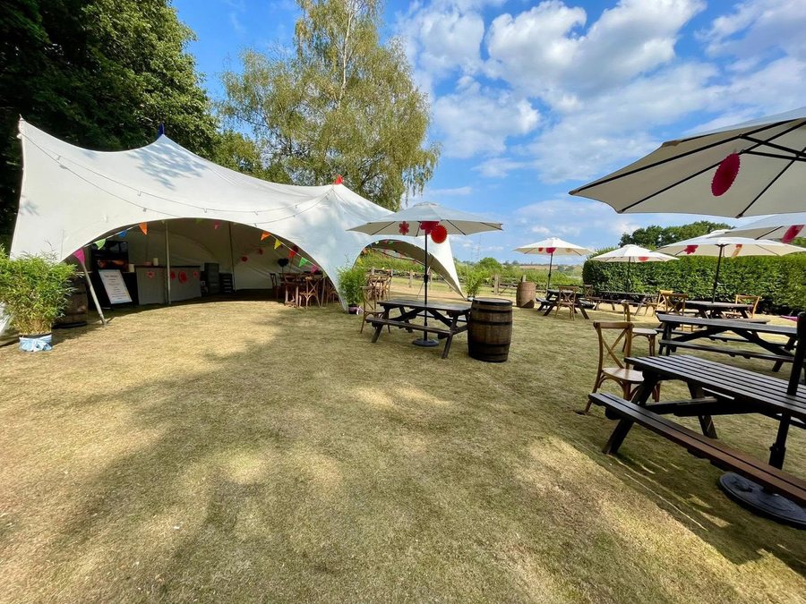MB Bars & Events bar set up inside a stretch tent at a summer wedding